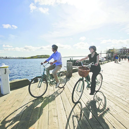 This is an image of two people biking at the Halifax Waterfront